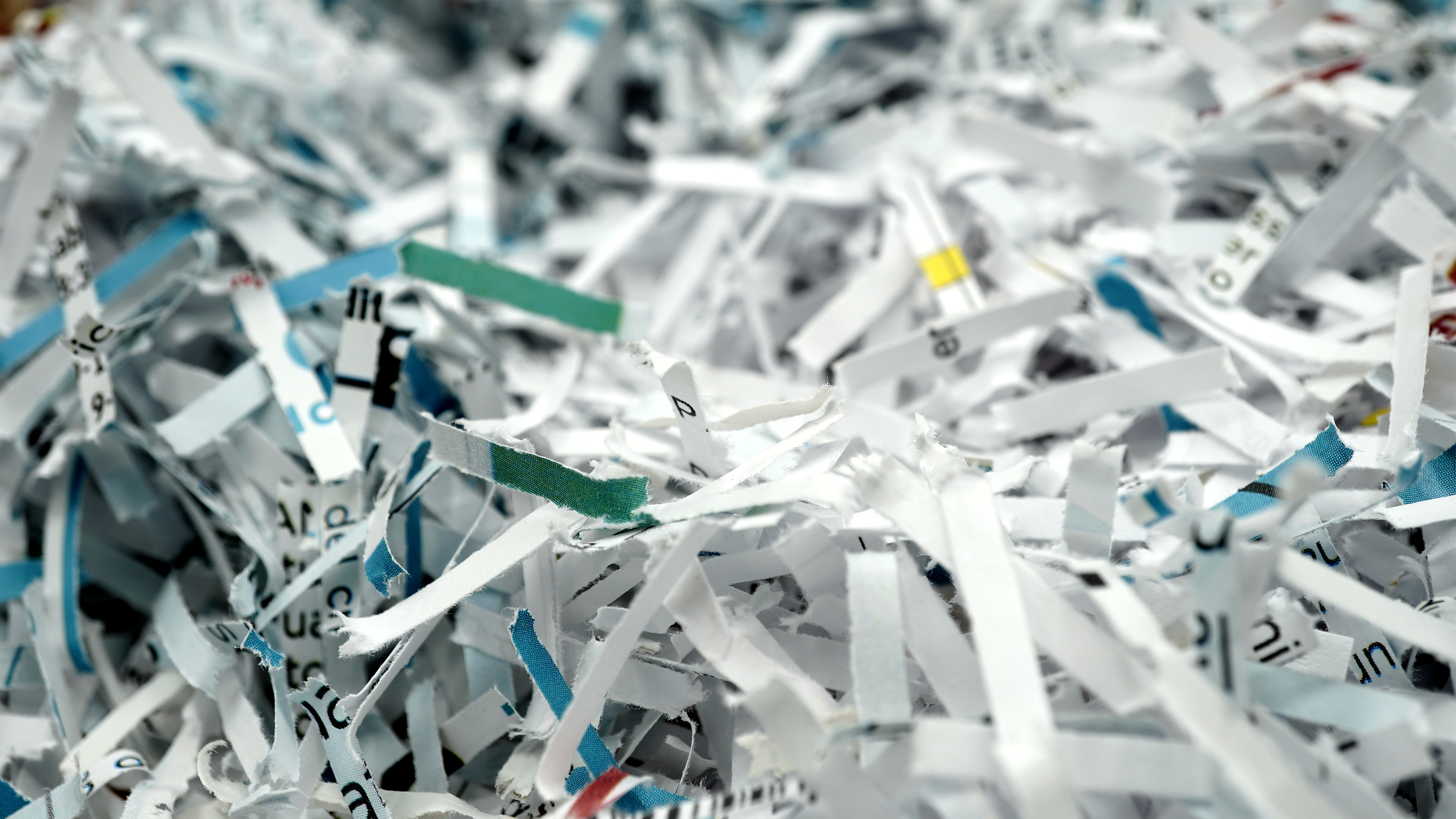 paper scraps of shredded documents seen in detail. Conceptual image for privacy, fake news