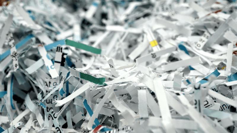 paper scraps of shredded documents seen in detail. Conceptual image for privacy, fake news