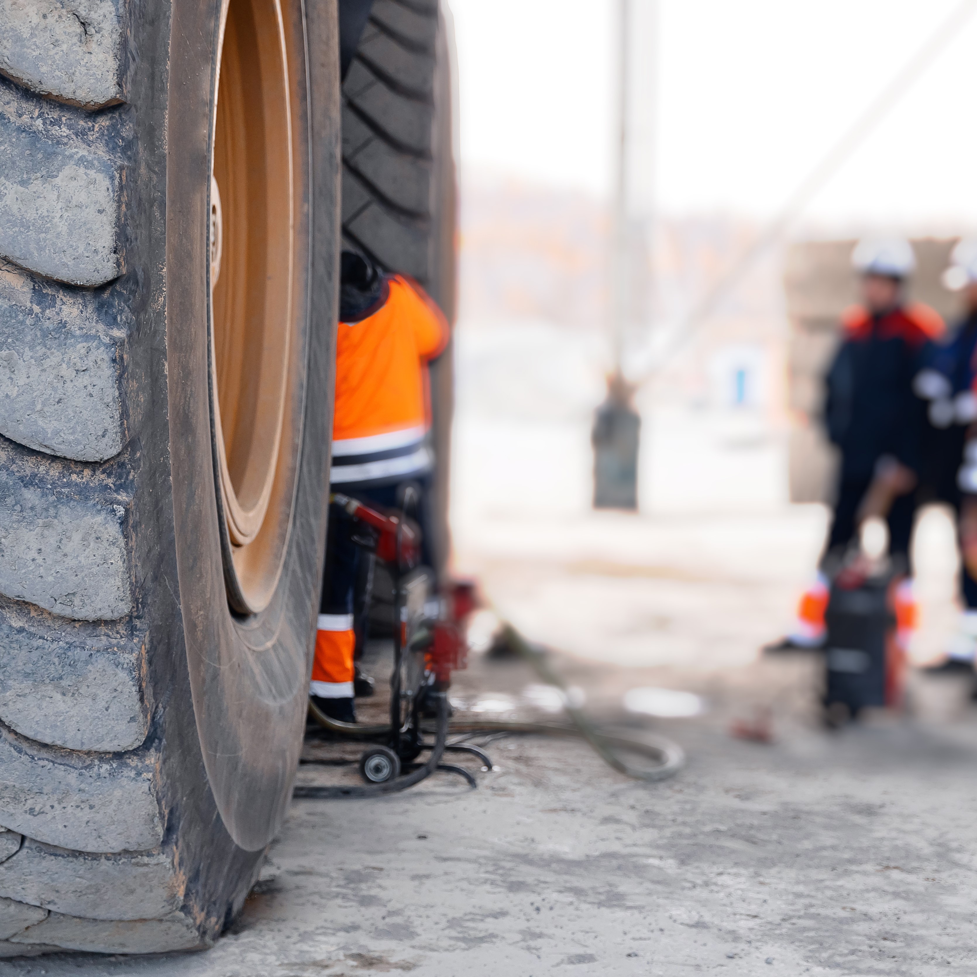 Replacing tires on wheels of mining dump car in garage. Maintenance fix service of industry truck