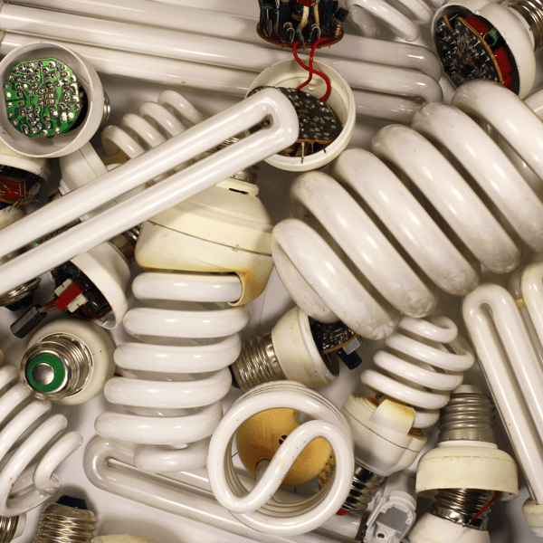 Old burnt fluorescent energy saving lamps. Hazardous and toxic electronic waste