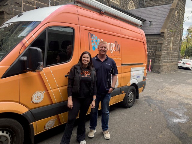 CW_Web_Asset_Justin and Georgie infront of Orange Sky van