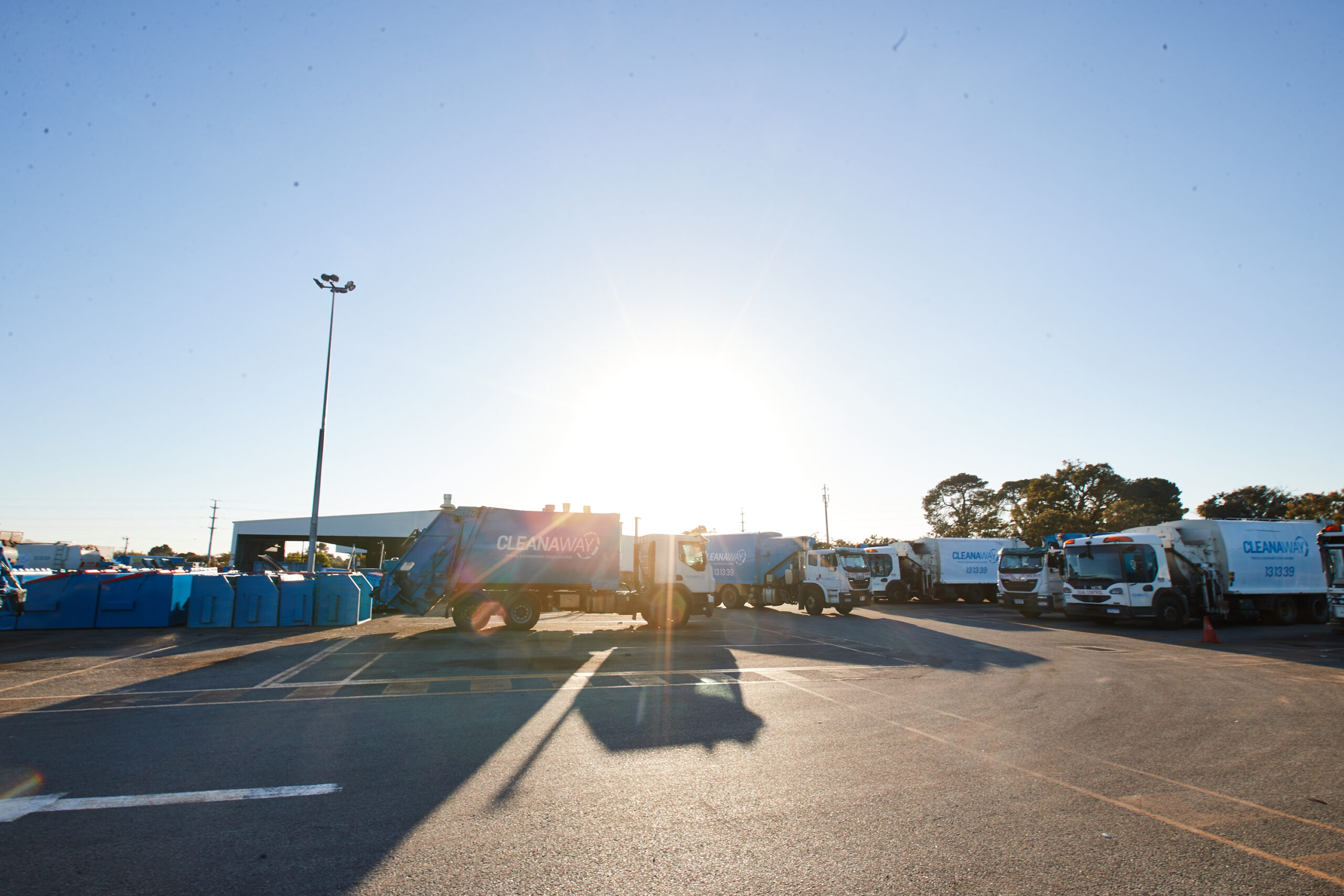Sun over Cleanaway trucks