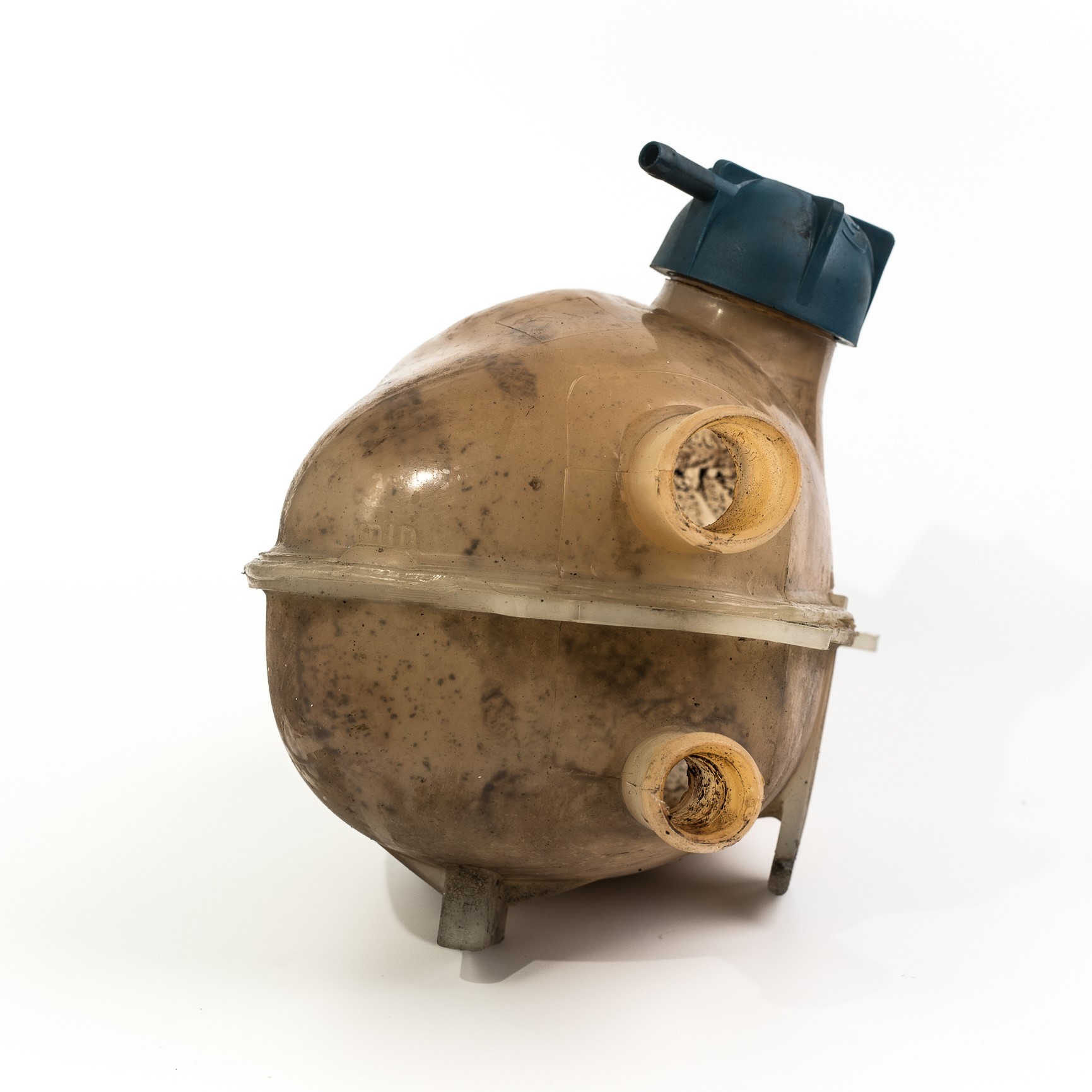 Old and worn rounded car coolant expansion tank on a white background, isolated on white. Worn automotive parts in dirty condition. Front view