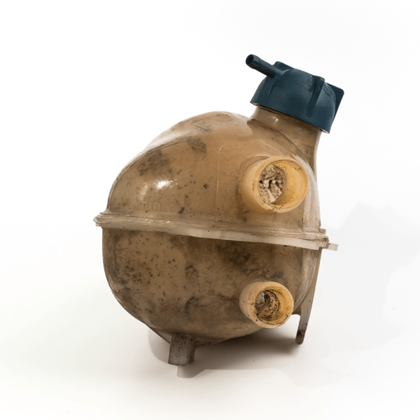 Old and worn rounded car coolant expansion tank on a white background, isolated on white. Worn automotive parts in dirty condition. Front view