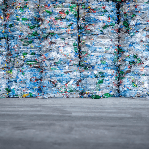 Large pile of plastic PET bottles compressed and ready for recycling. Separating and sorting garbage for modern recycle plant.